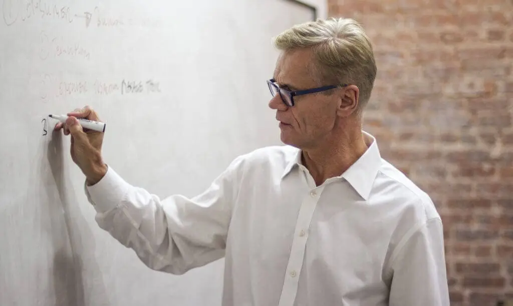 erich joachimsthaler working on a whiteboard