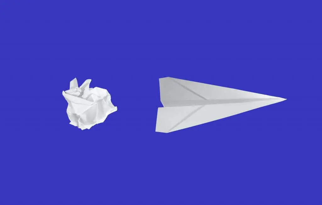 Paper airplanes and wad of paper