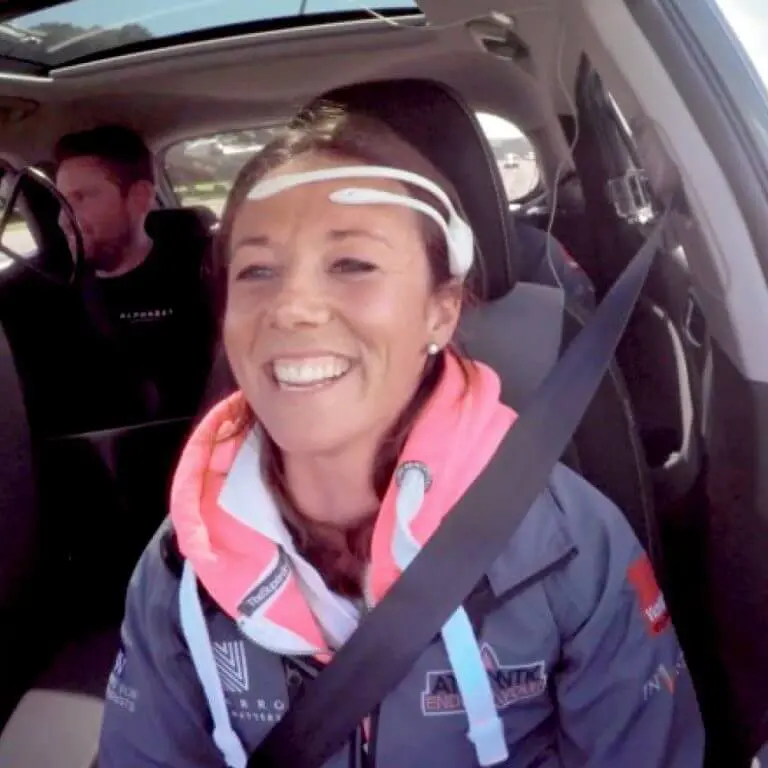 woman wearing headset driving car