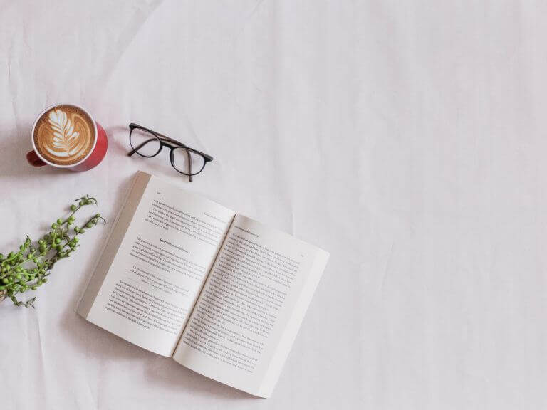 book, coffee, glasses on white table
