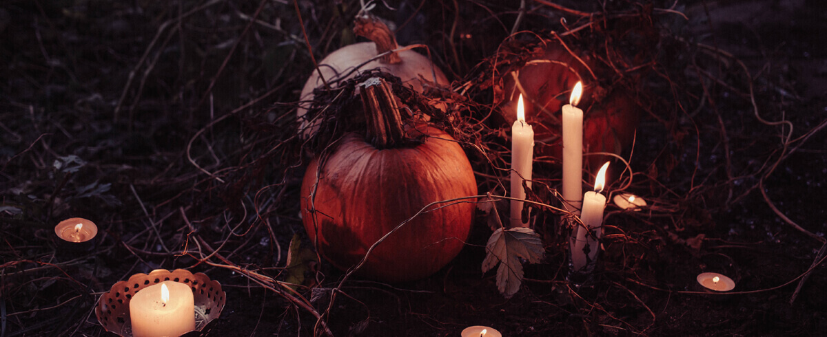 candles in a pumpkin patch