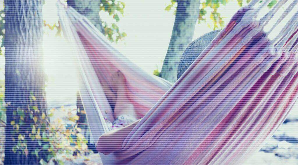 woman laying in hammock