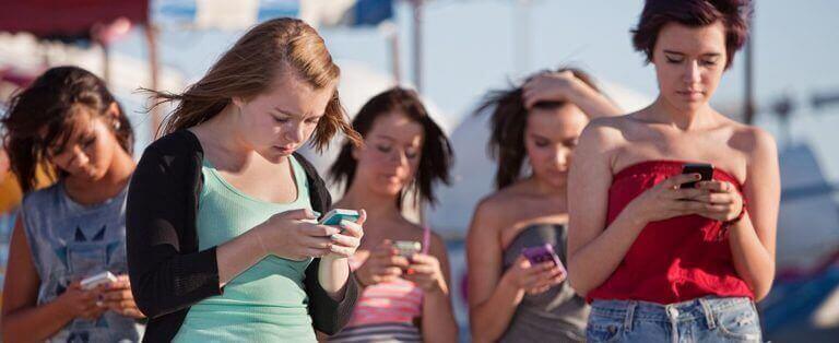 girls outside on their phones