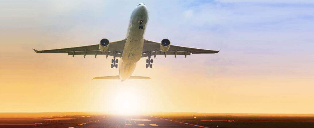 plane taking off in sunset