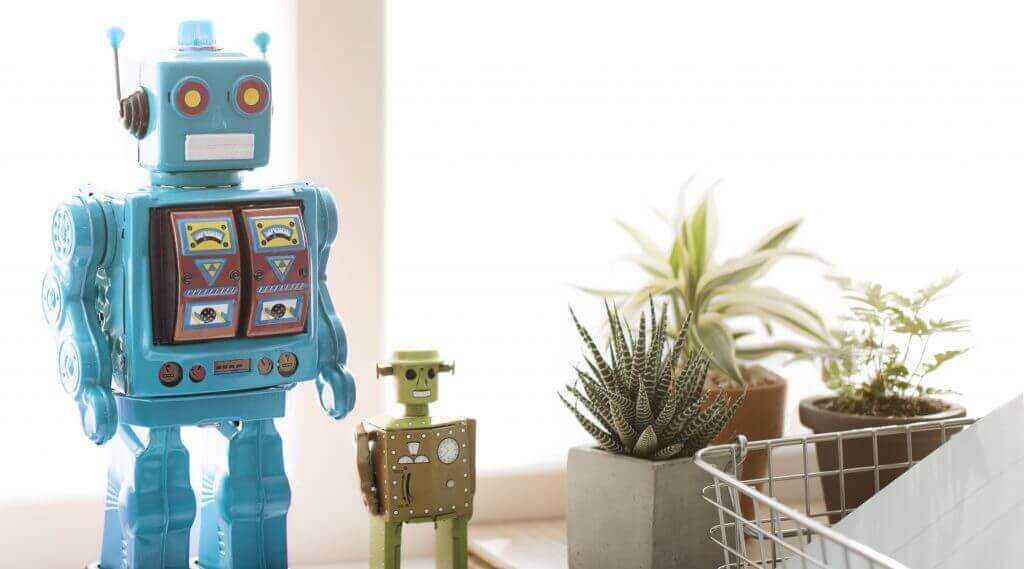blue robot and green robot next to plants