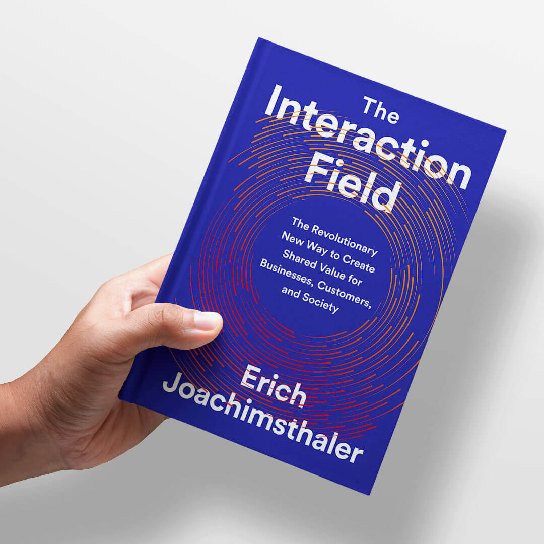 a hand is holding a book titled the interaction field