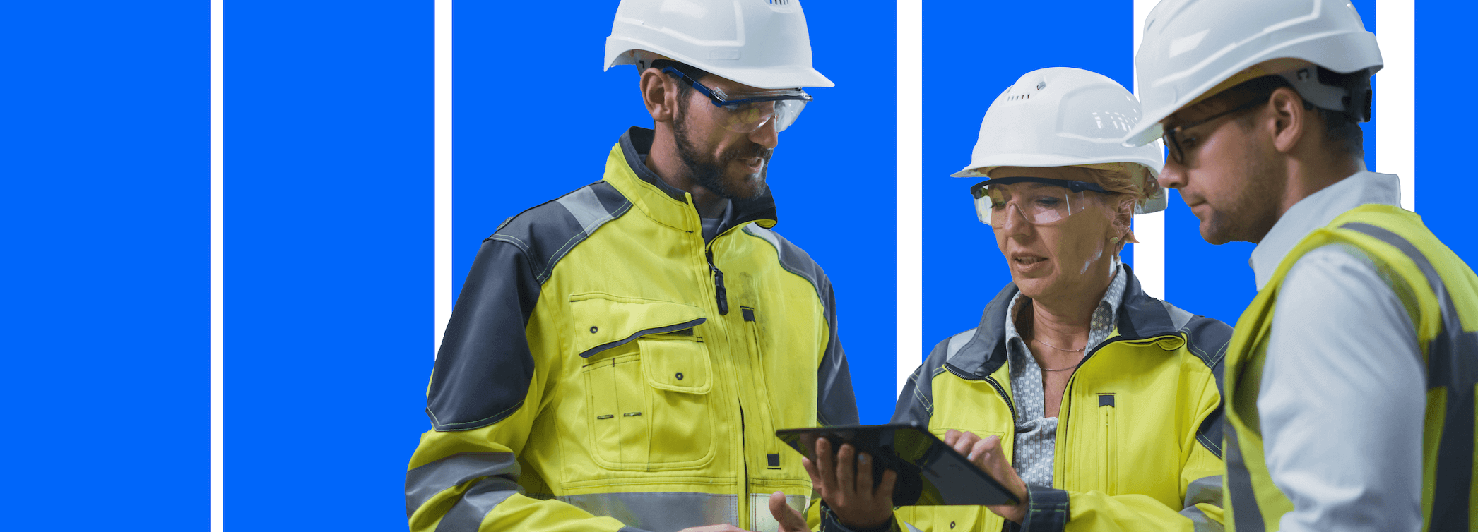 energy employees with hard hats looking at tablet