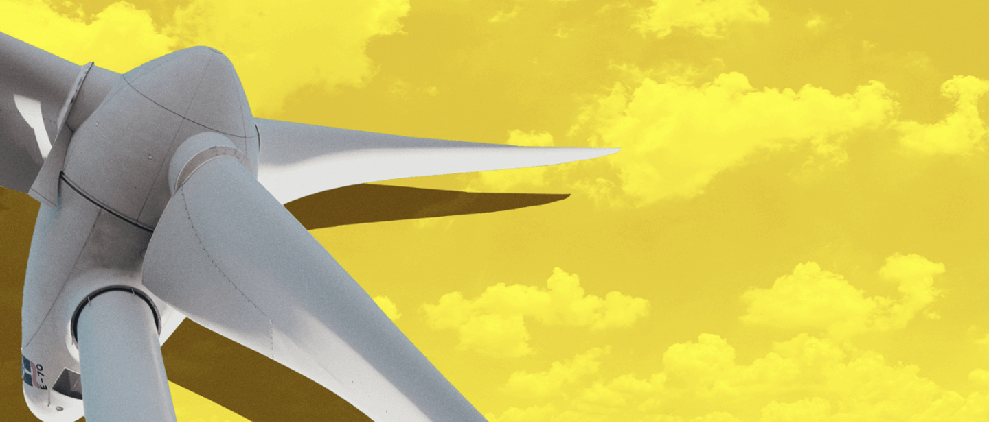 wind turbine against yellow sky