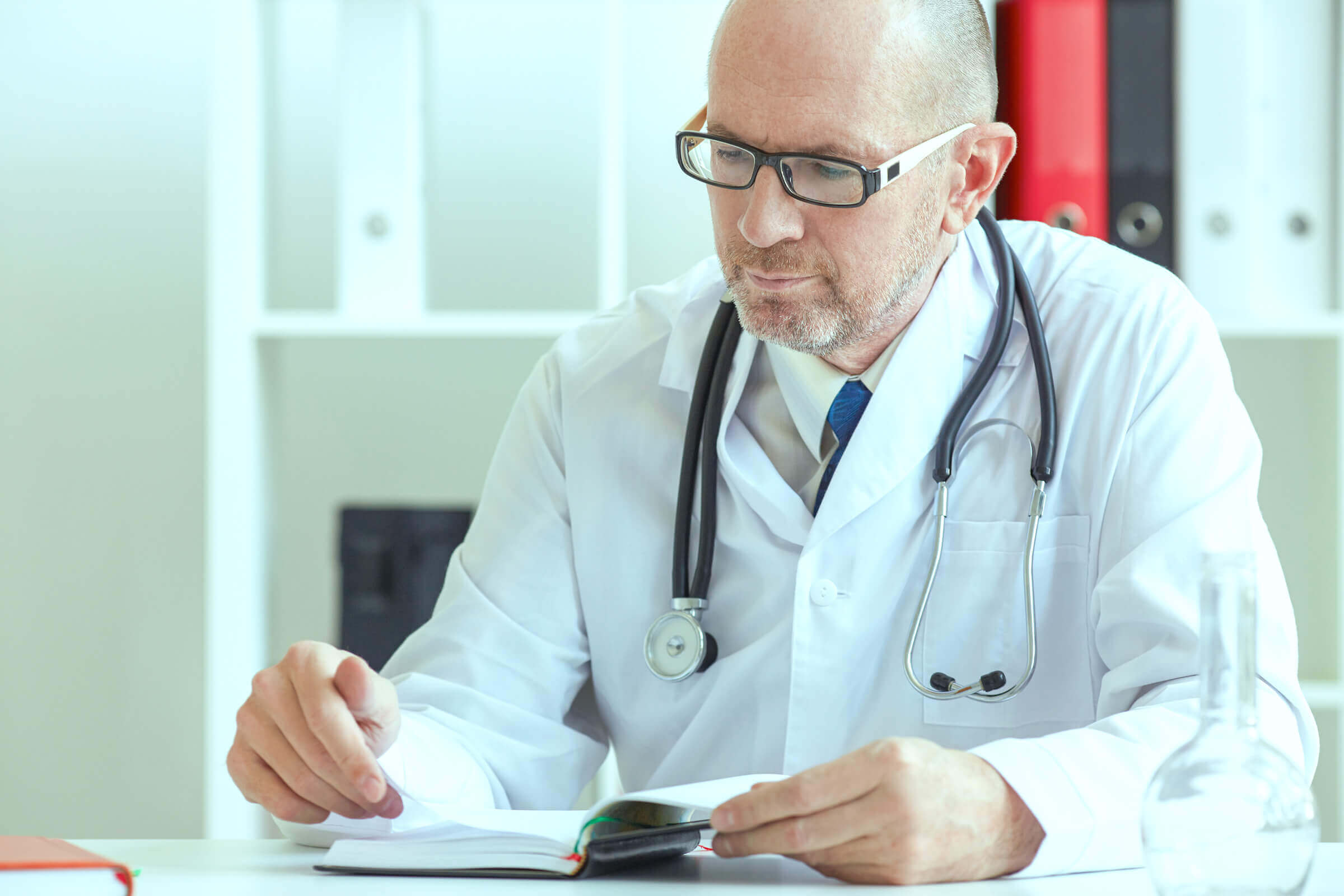 doctor looking at journal