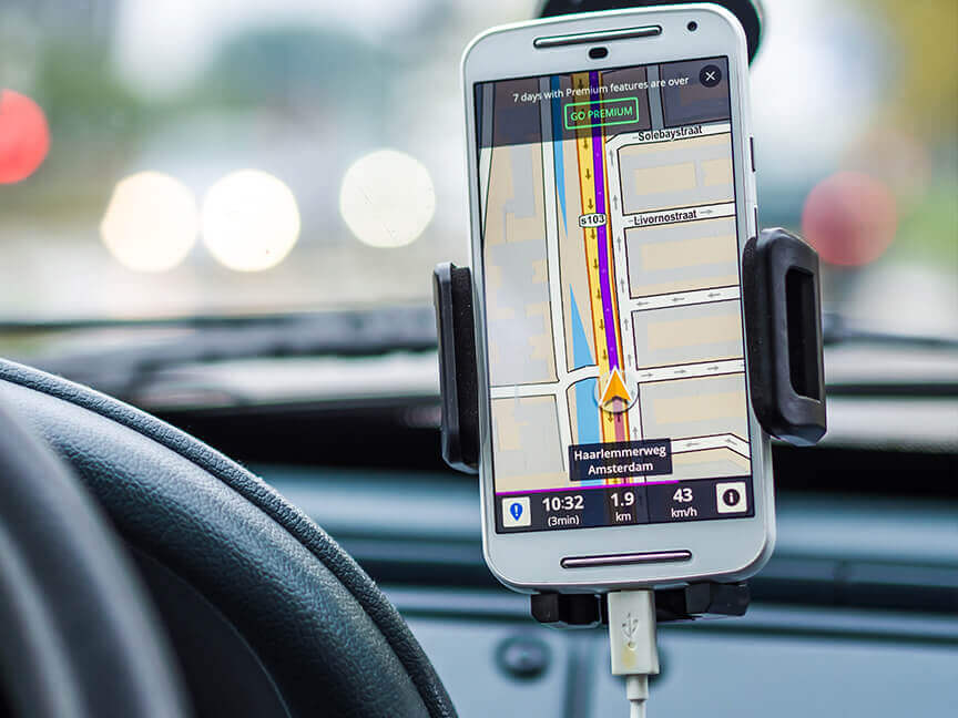 a phone in a car shows a map and says 7 days with premium features are over