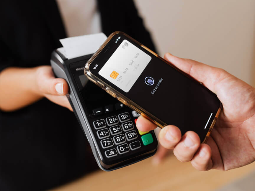 A person tapping their phone on a point of service machine to pay