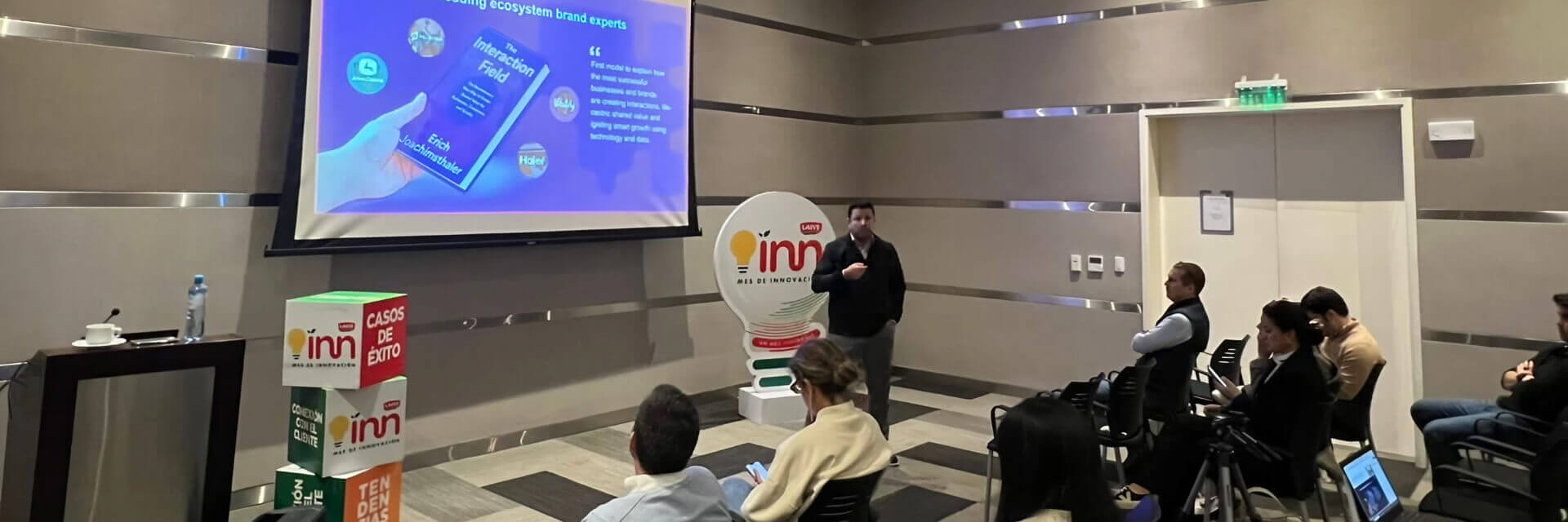 Mauricio Andujar presenting in front of a project screen